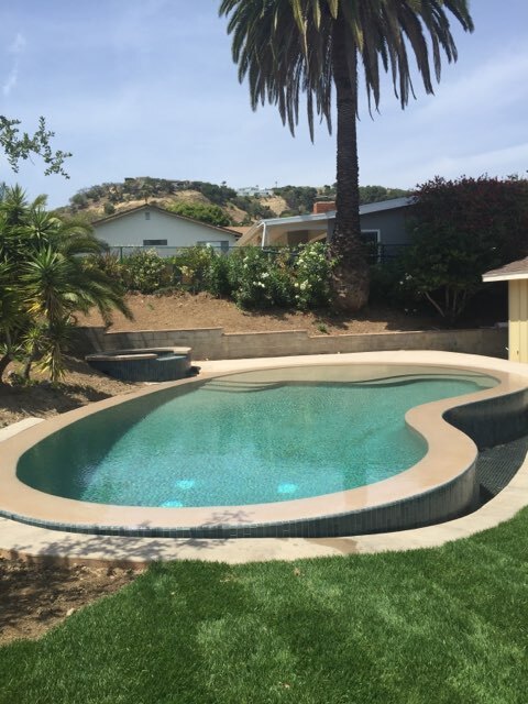 A pool built above ground with light blue water.