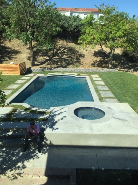 Pool with a circular jacuzzi.