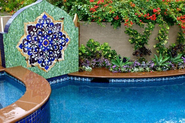 Pool with a flower pattern painted on the wall next to it.