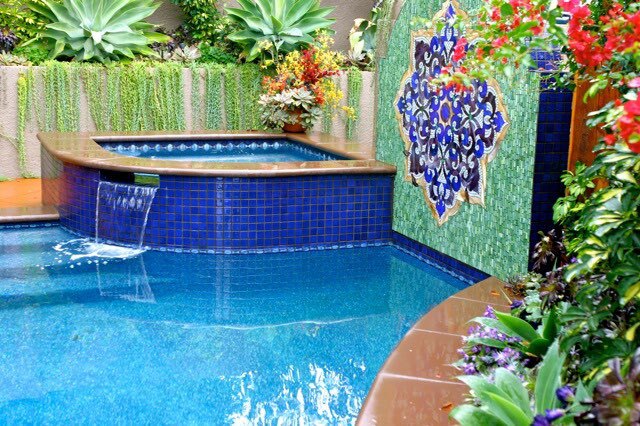 Pool with a flower pattern painted on the wall next to it.