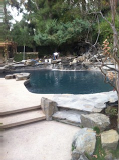 A pool with rocky landscape.