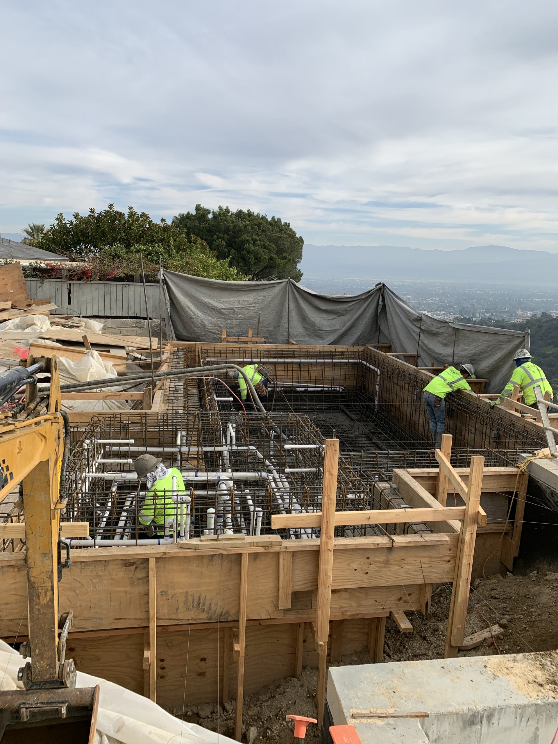 Construction workers working on a pool.