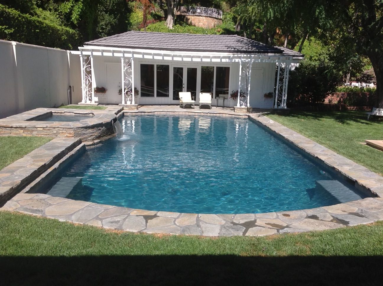 A pool by a patio.