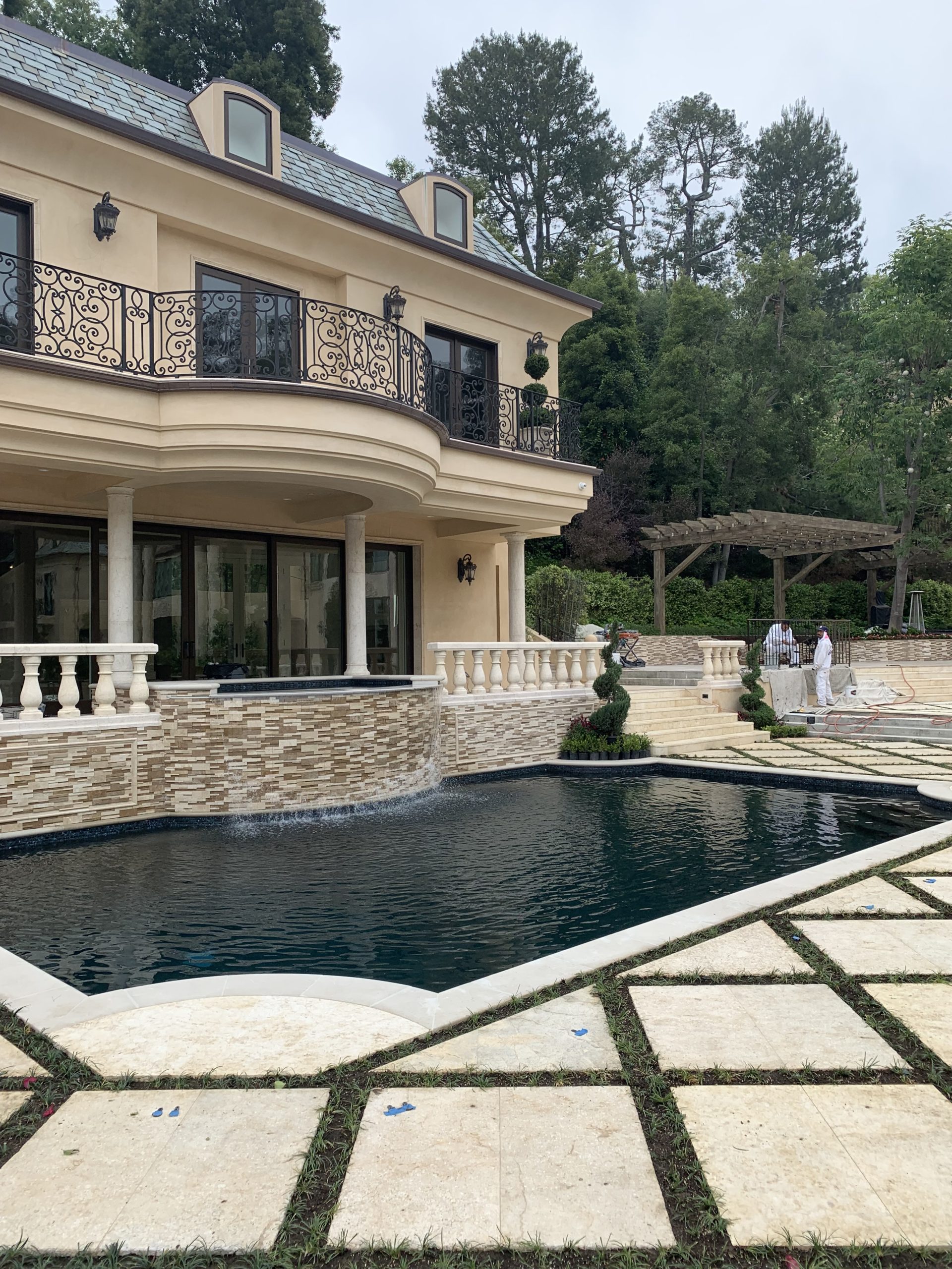 A pool next to a house.