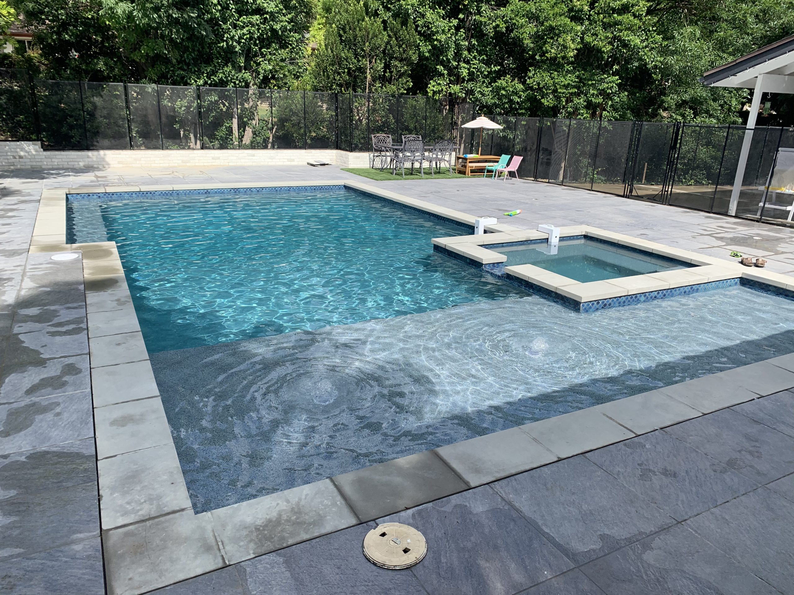 AA pool with a jacuzzi inside.