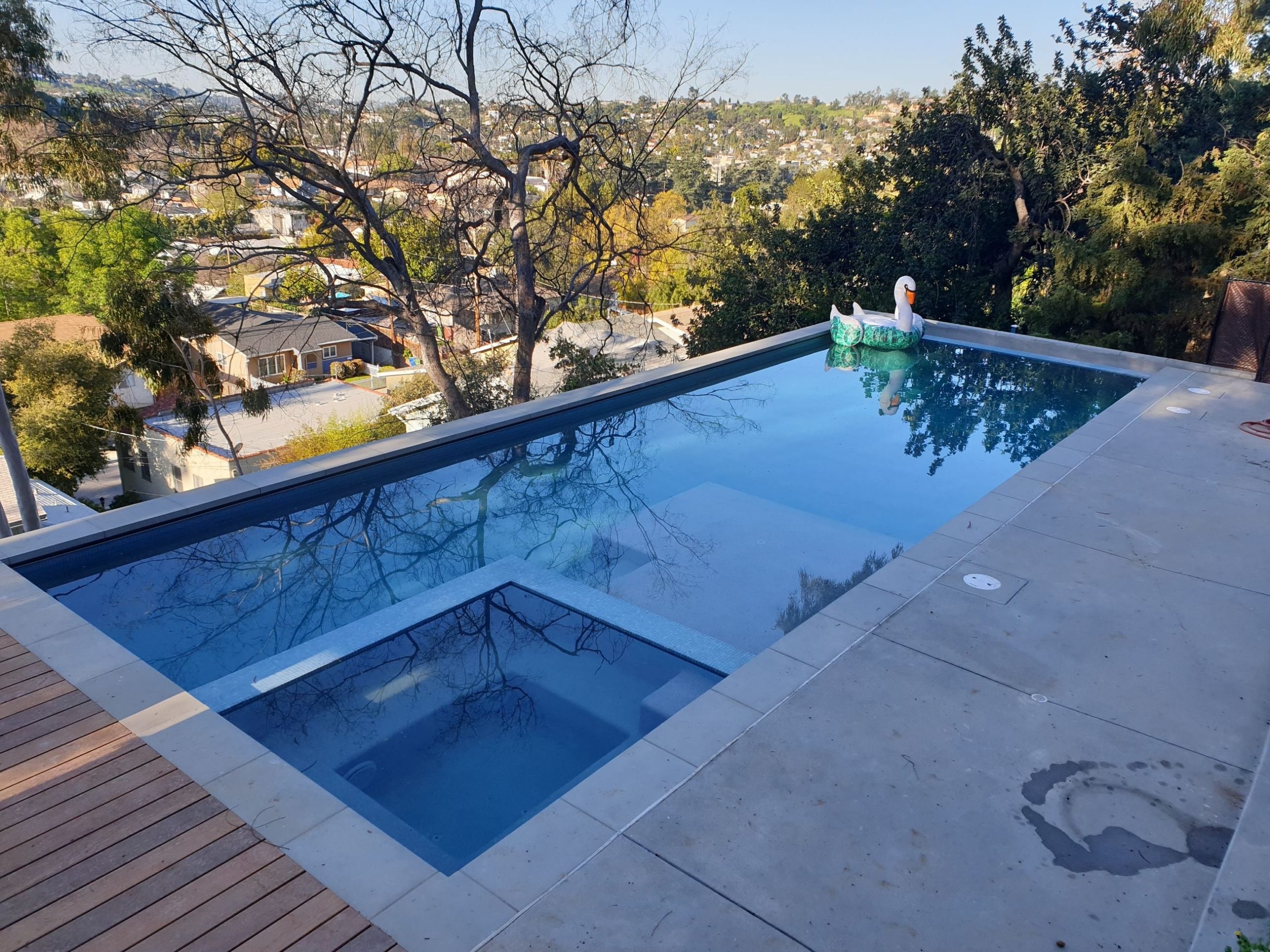 A pool with a swan floaty in it.