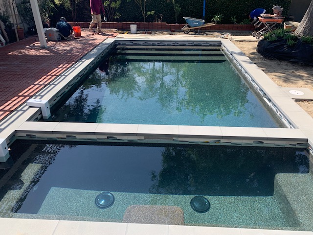 Pool split near the end with a jacuzzi.